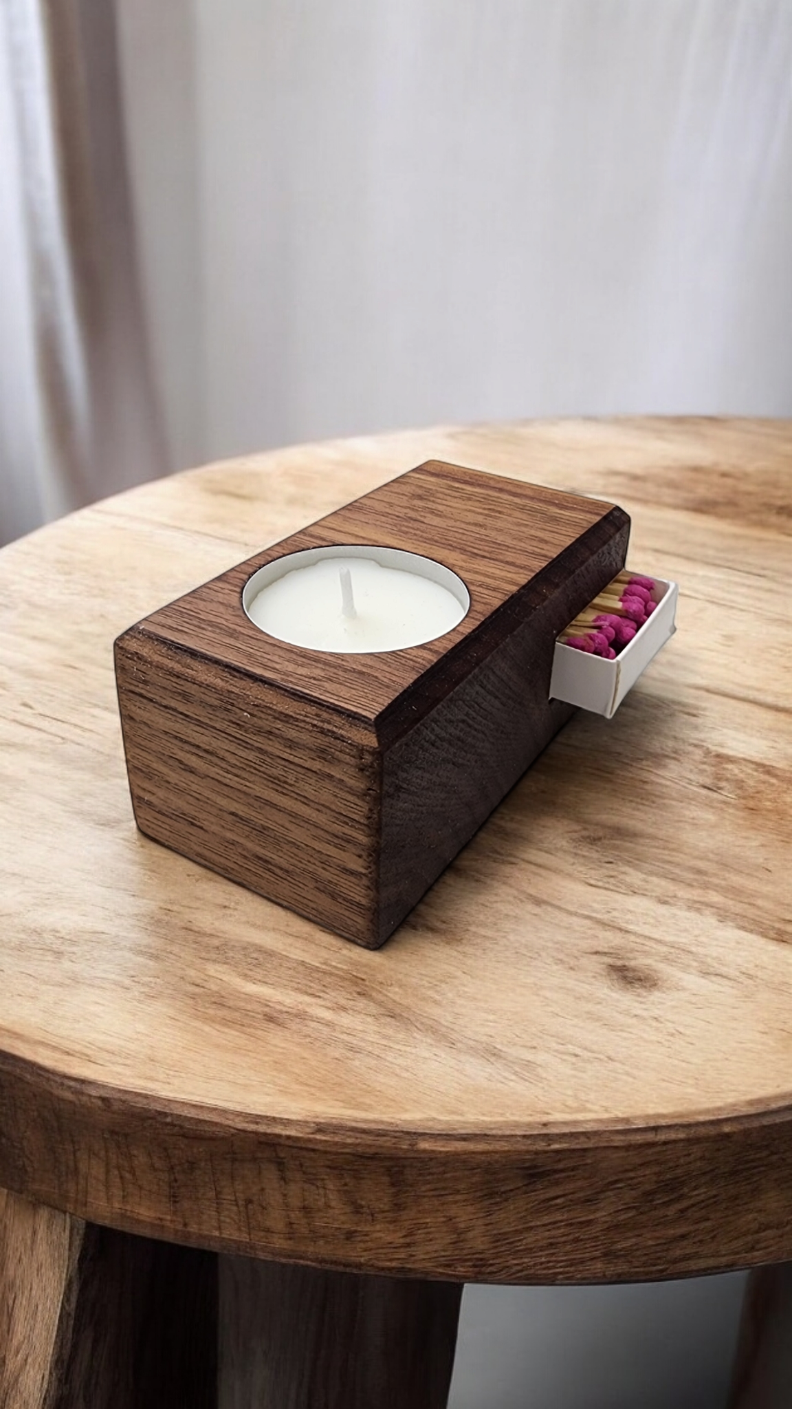 Candle holder with integrated storage for matchbox or lighter